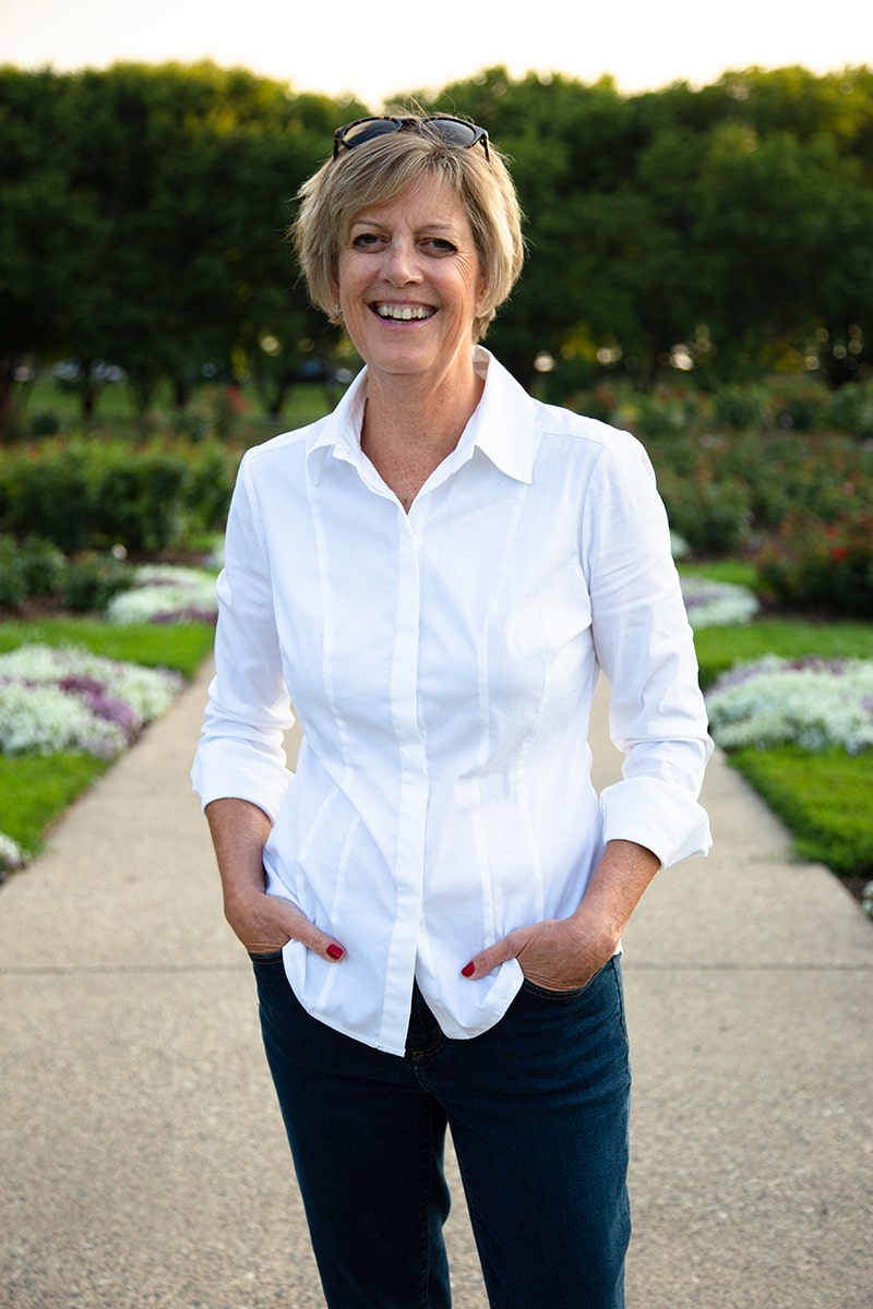 Sarah Parker standing on a path with her hands in her pockets